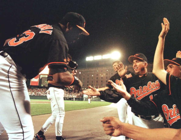 1996 - Baltimore Orioles Eddie Murray (L) is greeted by manager Davey Johnson (R)  ( TED MATHIAS/AFP/Getty Images)