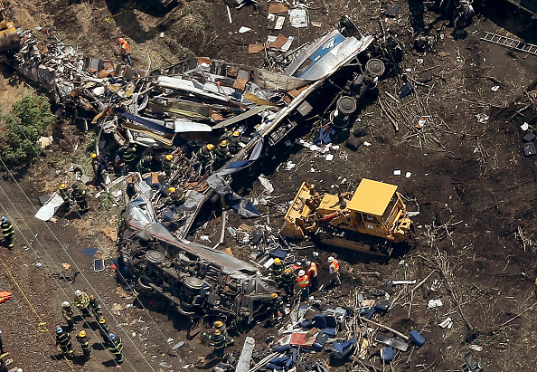 PHILADELPHIA, PA - MAY 13:  Investigators and first responders work near the wreckage of an Amtrak passenger train carrying more than 200 passengers from Washington, DC to New York that derailed late last night May 13, 2015 in north Philadelphia, Pennsylvania. At least five people were killed and more than 50 others were injured in the crash.  (Photo by Win McNamee/Getty Images)