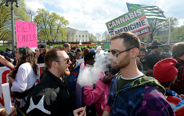 Advocates for the legalization of marijuana light up in front of the White House during a demonstration by dozens 02 April, 2016 in Washington, DC.   Many called for the de-criminalization of pot and pointed to the medical benefits. At least two smokers were cited with mere possession, a $25 fine in the District of Columbia.    / AFP / Mike Theiler        (Photo credit should read MIKE THEILER/AFP/Getty Images)